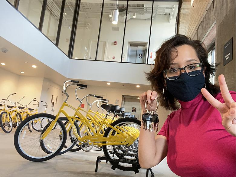 Daniela Aponte'23 poses with Sinnissippi Cruiser bikes at the Powerhouse.